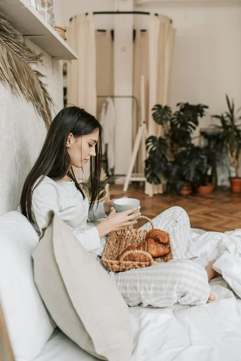 woman eating comfort food in bed. ADHD linked to porn use in women